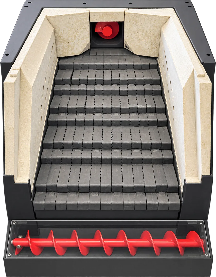 The firebox with ceramic walls, the moving stepped grate and the ash screw at the bottom