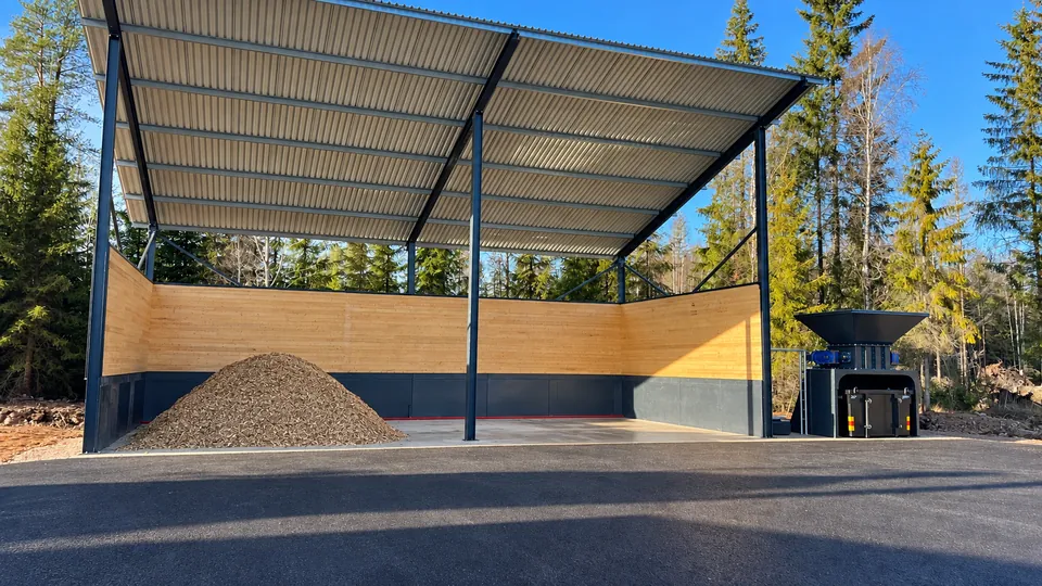 The carport with the wood chips under the roof and the Shredder alongside.