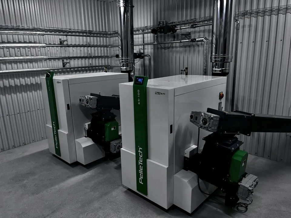 Two PelleTech Multiauto 100 boilers in the boiler room.