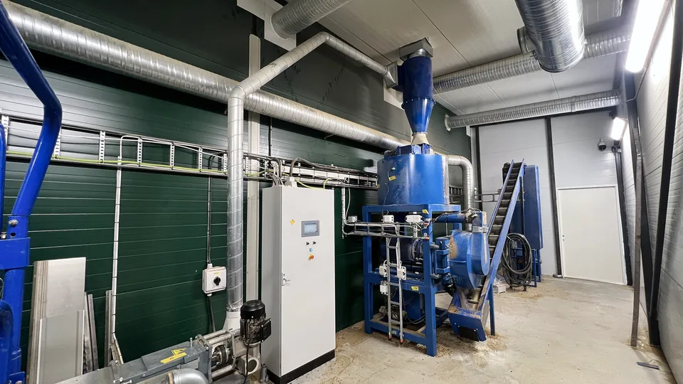 The pellet line: the cyclone at the top, the pellet press and the elevator up to the cooling tower.