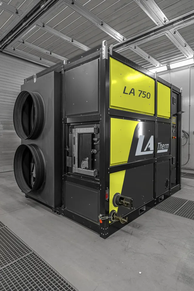 The hot-air boiler, with the two round air connections on the side.